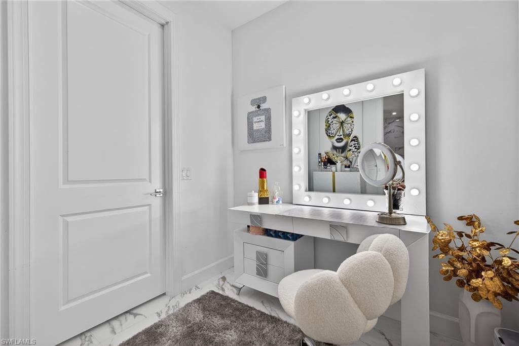 Bathroom with vanity and marble finish floors