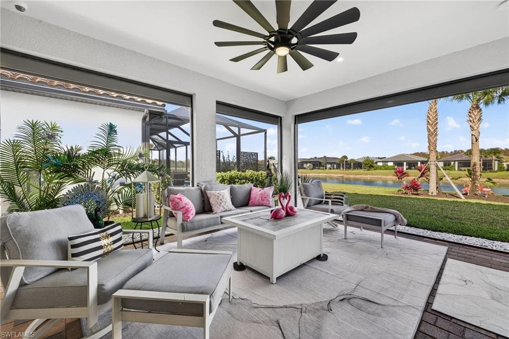 Sunroom featuring a water view