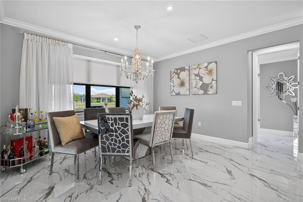 Dining space with crown molding, recessed lighting, a chandelier, and light marble finish floors
