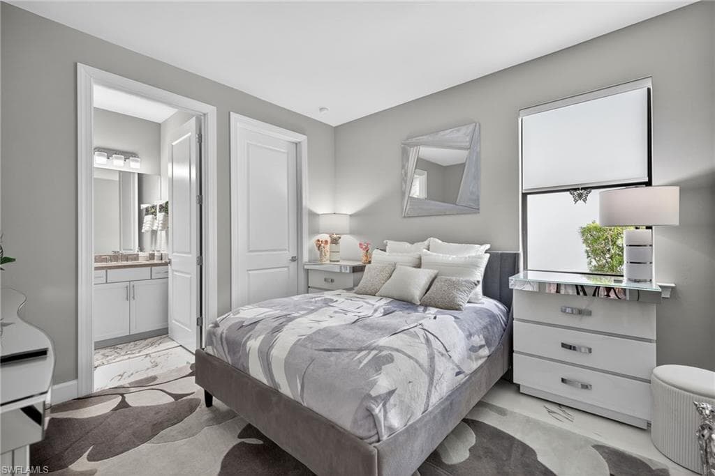 Bedroom with baseboards and ensuite bath