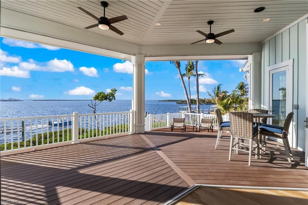 Upper deck off great room offers an incredible outdoor living space - a great way to spend the evenings - enjoy the dolphins and the sunsets! There are electronic shade screens that make this space even more enjoyable!