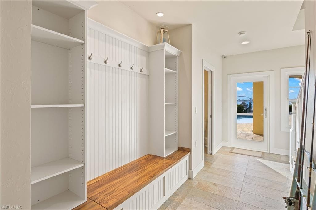 Downstairs mudroom with bathroom and access to the back patio and pool area!