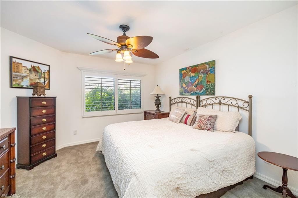 Bedroom with light carpet and ceiling fan