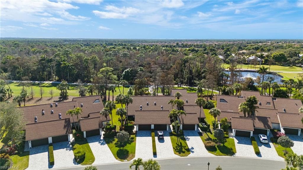 Aerial perspective of suburban area featuring a golf course