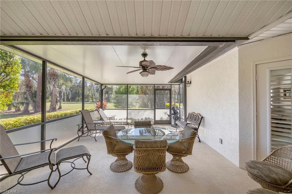 Sunroom featuring a ceiling fan and outdoor dining space
