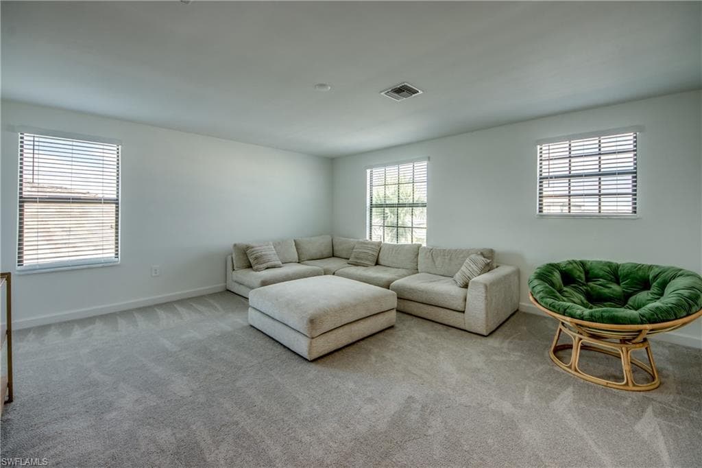 Carpeted living area with baseboards