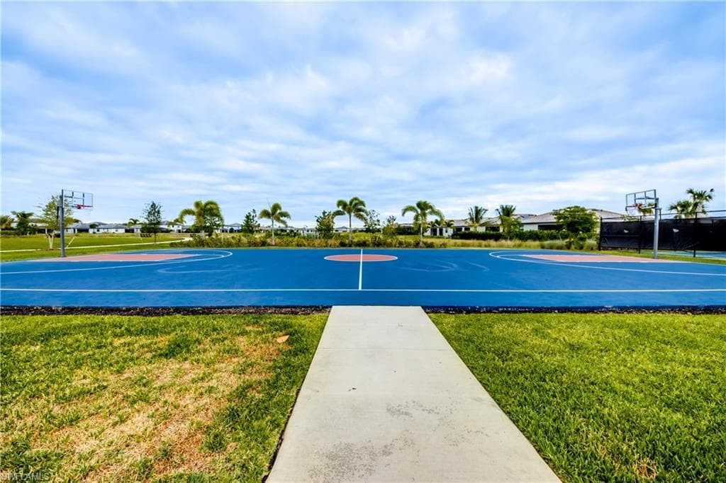 View of basketball court featuring community basketball court and a lawn