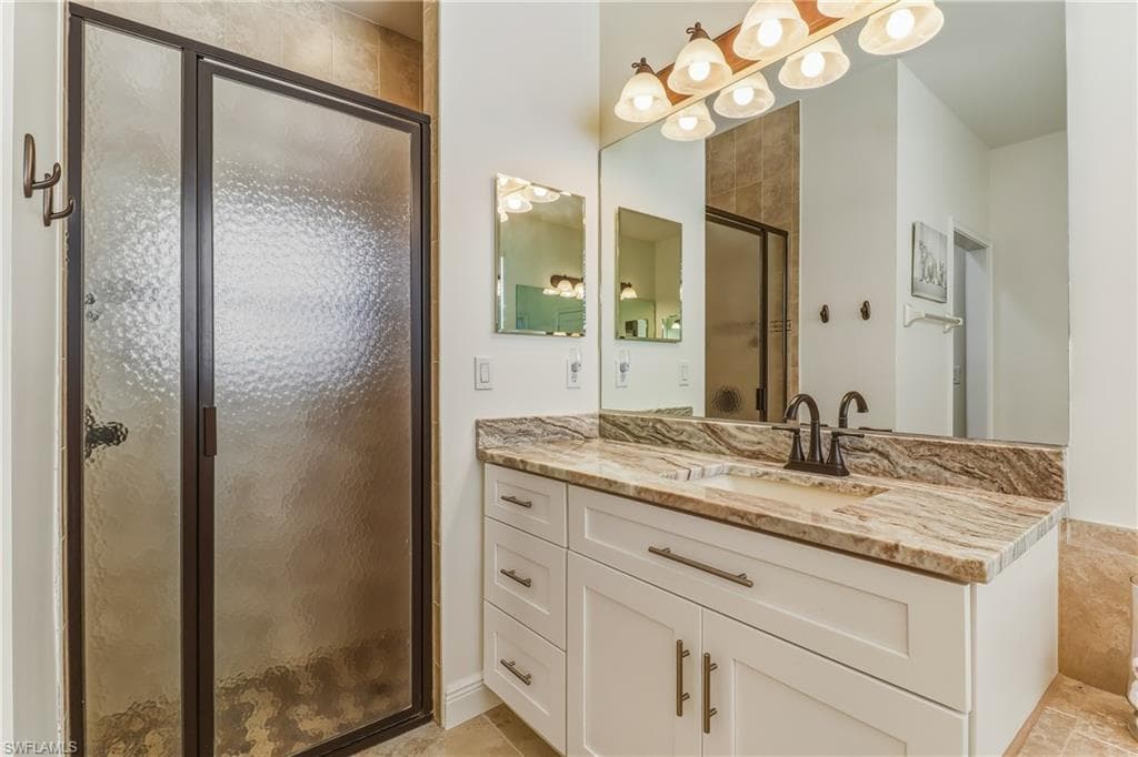 Full bathroom featuring a stall shower and vanity