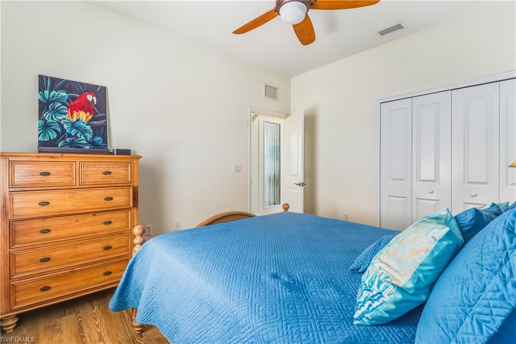 Bedroom featuring wood finished floors, a ceiling fan, and a closet