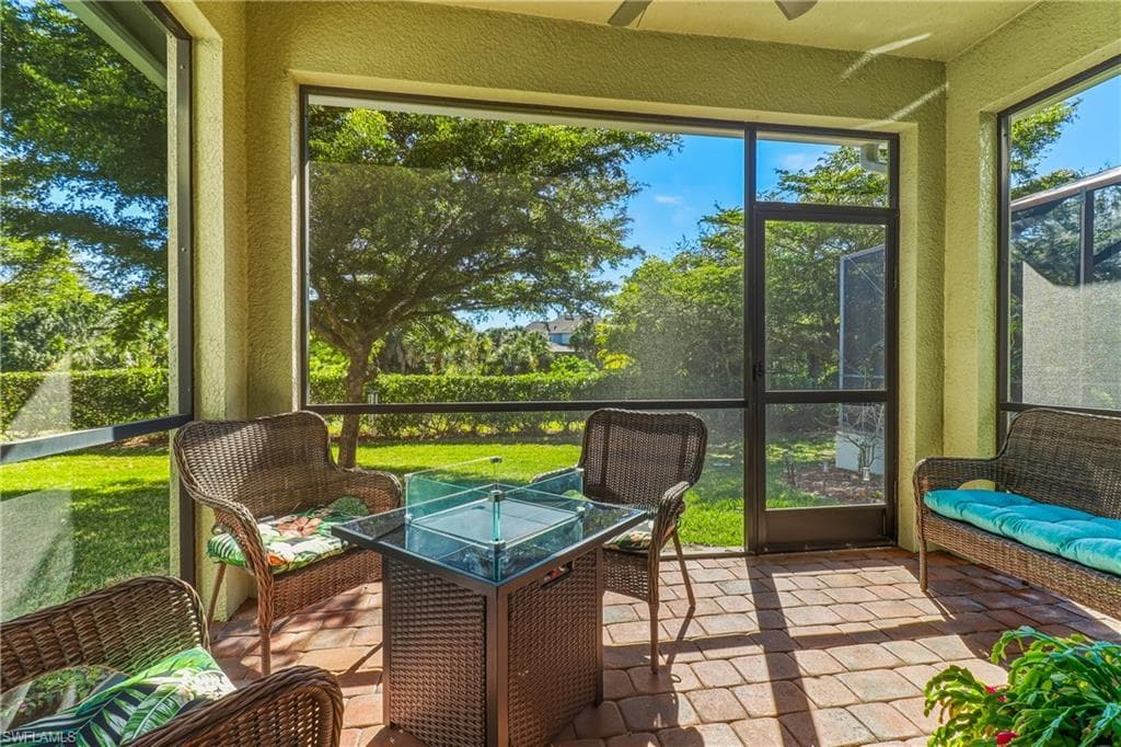 Sunroom / solarium with a ceiling fan and an outdoor hangout area