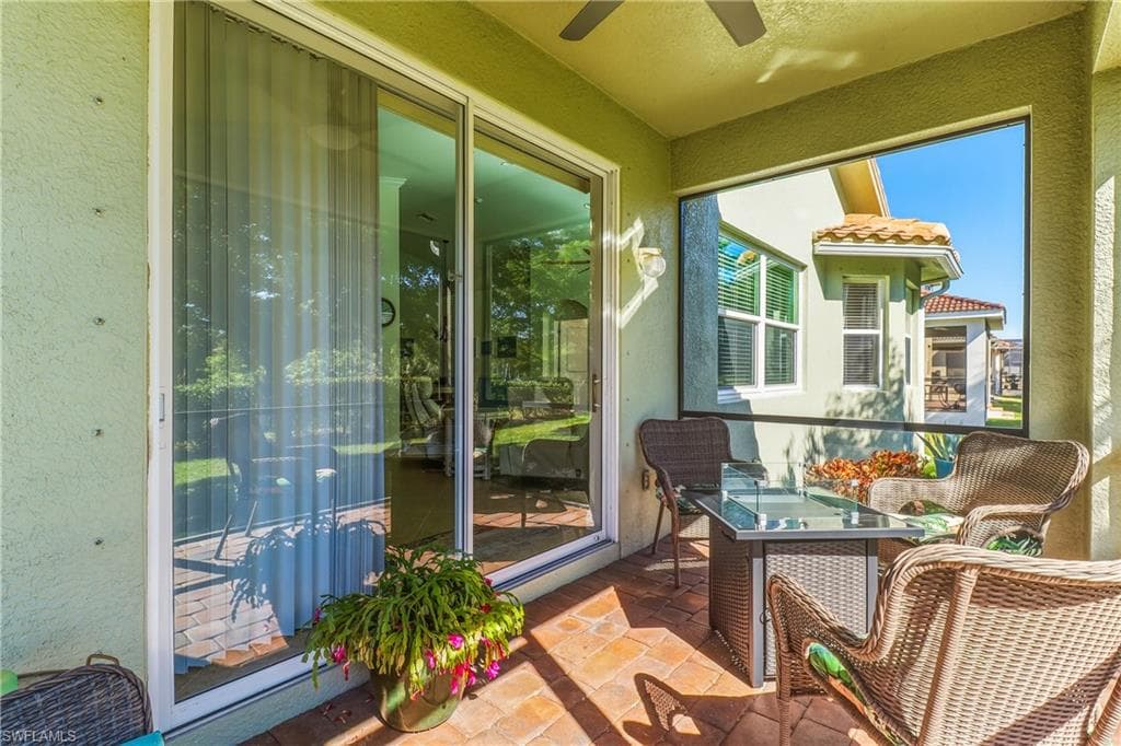 Sunroom featuring a ceiling fan and outdoor dining area