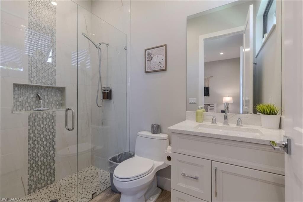 Full bath featuring vanity and a shower stall