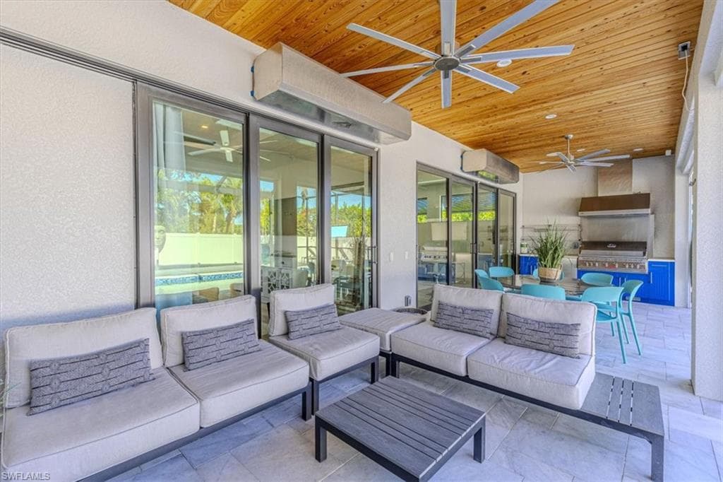 View of patio / terrace with ceiling fan, exterior kitchen, an outdoor hangout area, and outdoor dining area