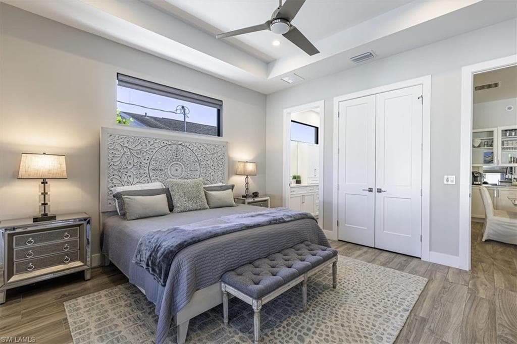 Bedroom featuring ceiling fan, wood finished floors, connected bathroom, a closet, and recessed lighting