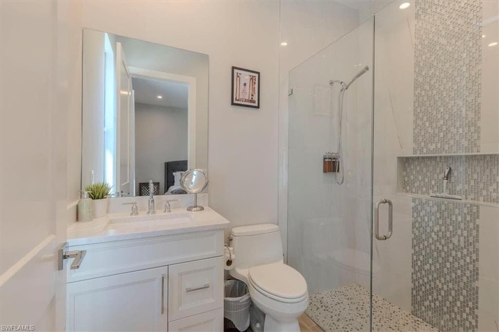 Full bath with vanity and a stall shower