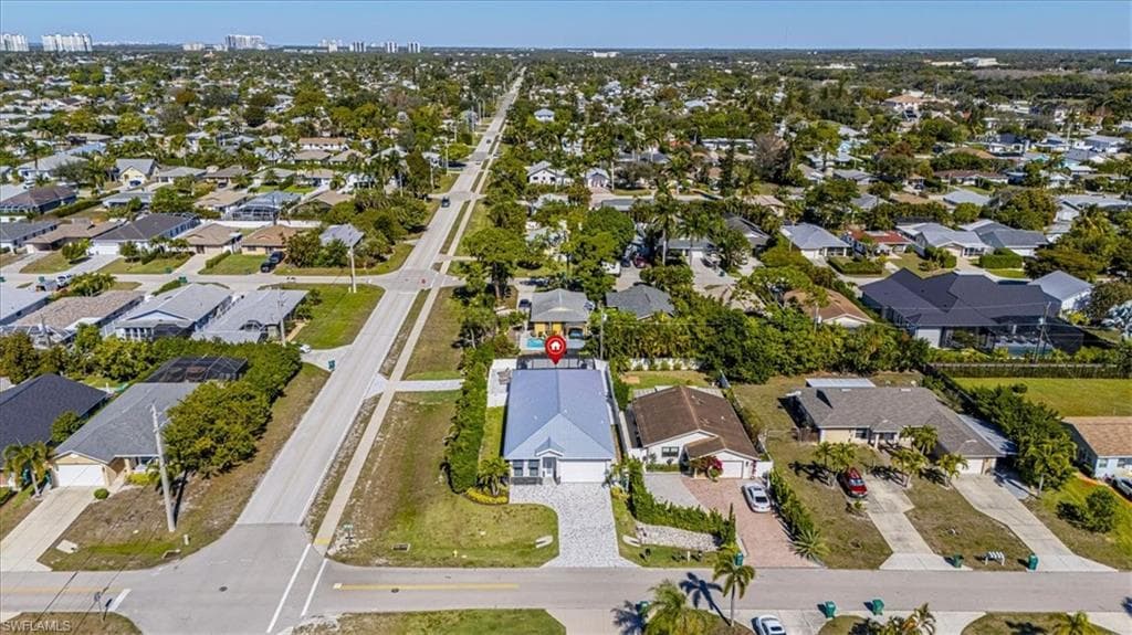 Aerial view of property's location featuring nearby suburban area