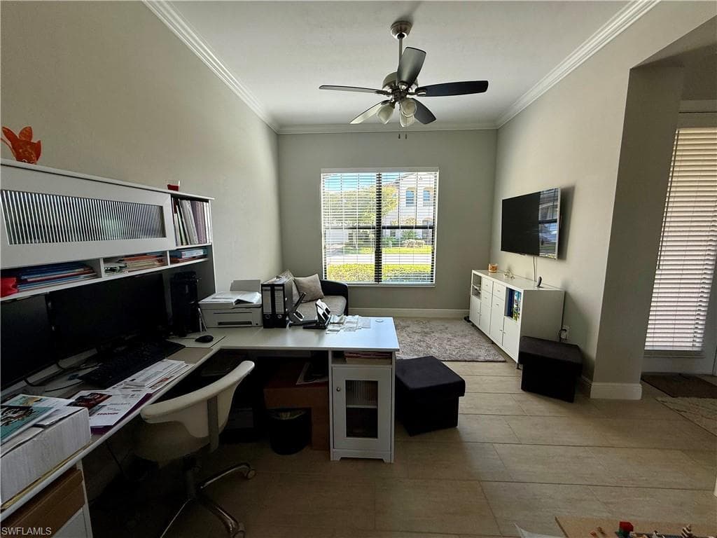 Office area with crown molding and a ceiling fan