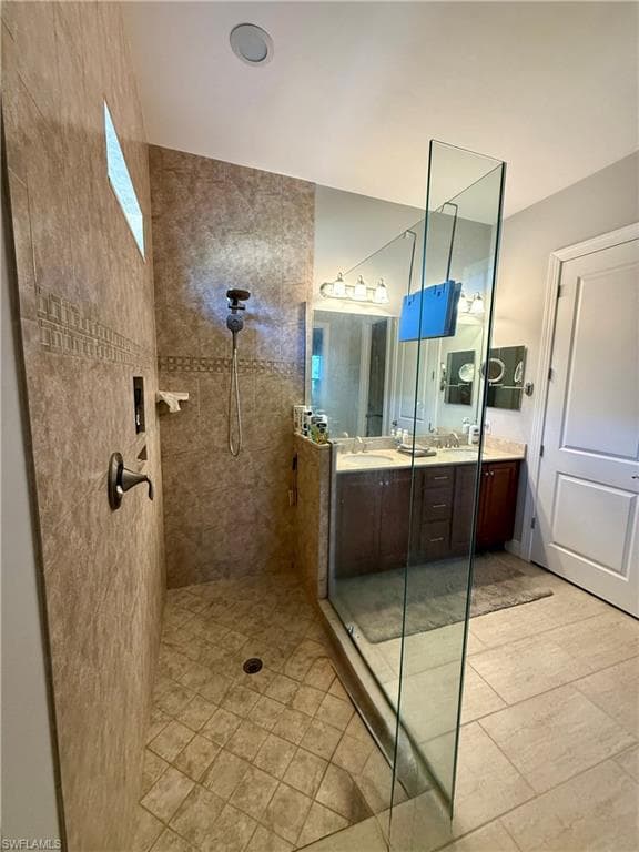 Full bath featuring walk in shower and double vanity