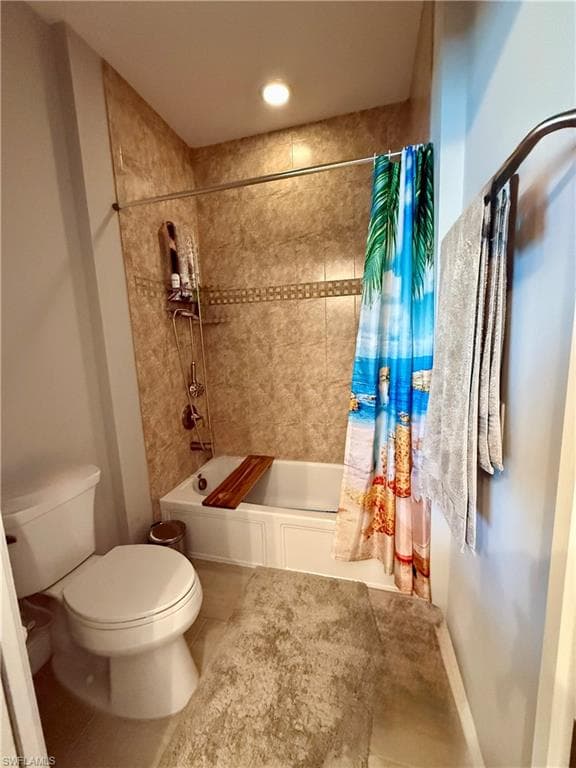 Bathroom featuring shower / bathtub combination with curtain and tile patterned floors