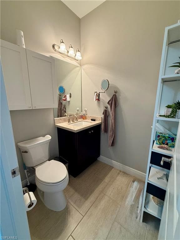 Half bath featuring vanity and toilet