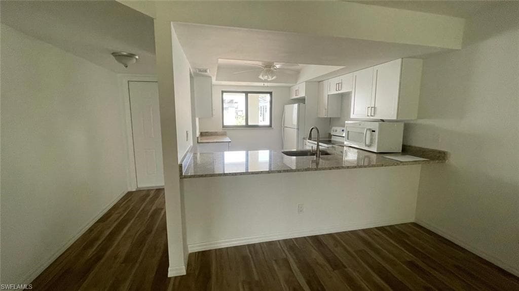 Kitchen featuring white cabinets