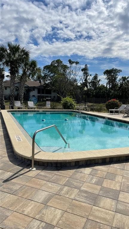 Community pool with a patio