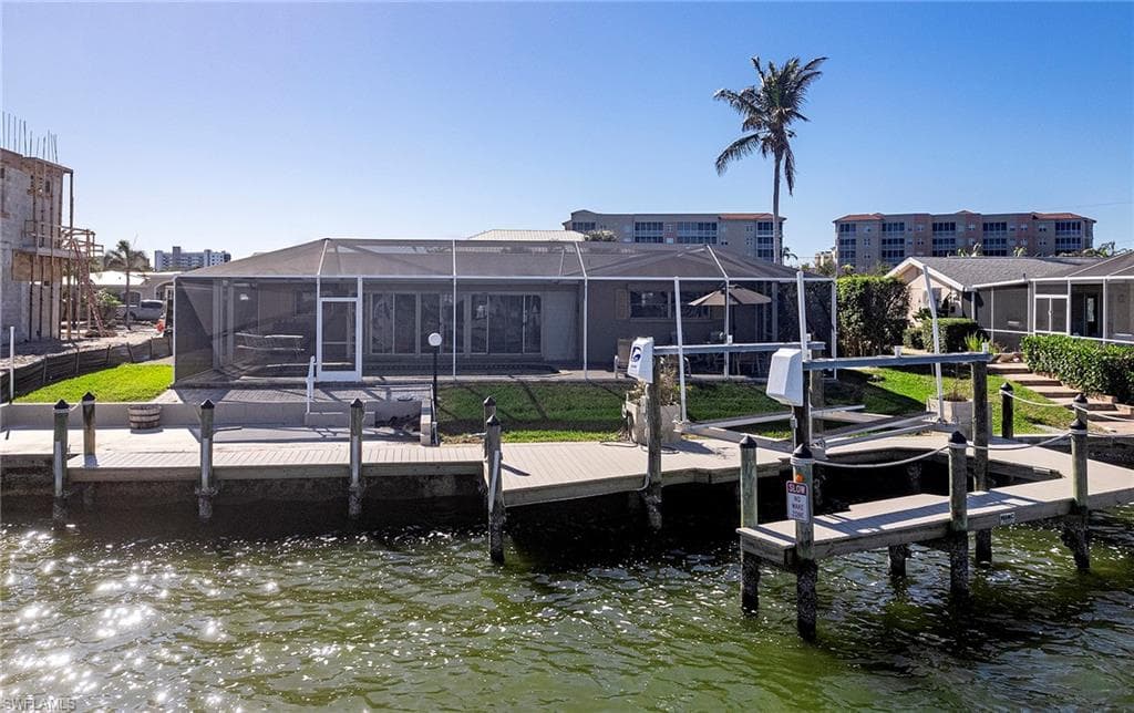 Dock area with a water view and glass enclosure