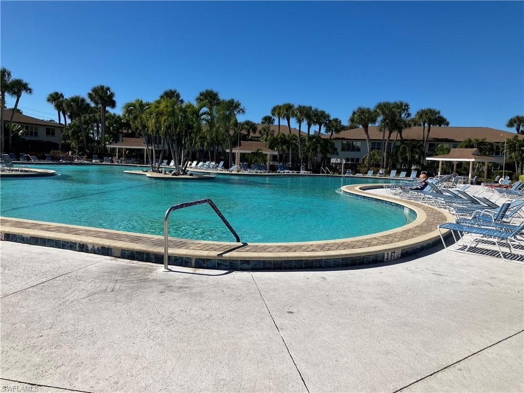 Community pool with a patio