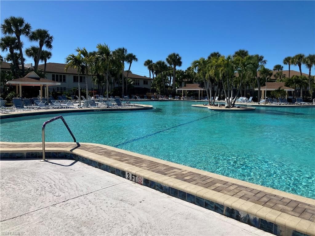 Community pool with a patio area and a gazebo