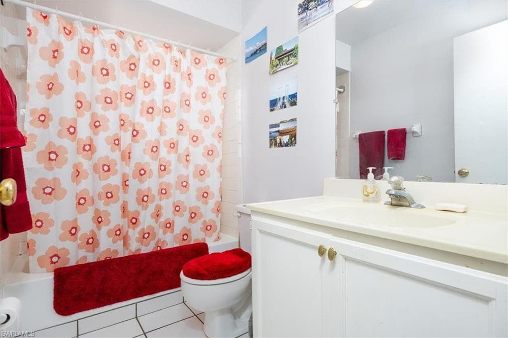 Bathroom featuring shower / bath combo, vanity, and tile patterned flooring