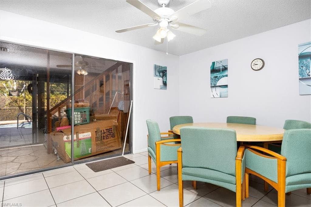 Tiled dining space with ceiling fan