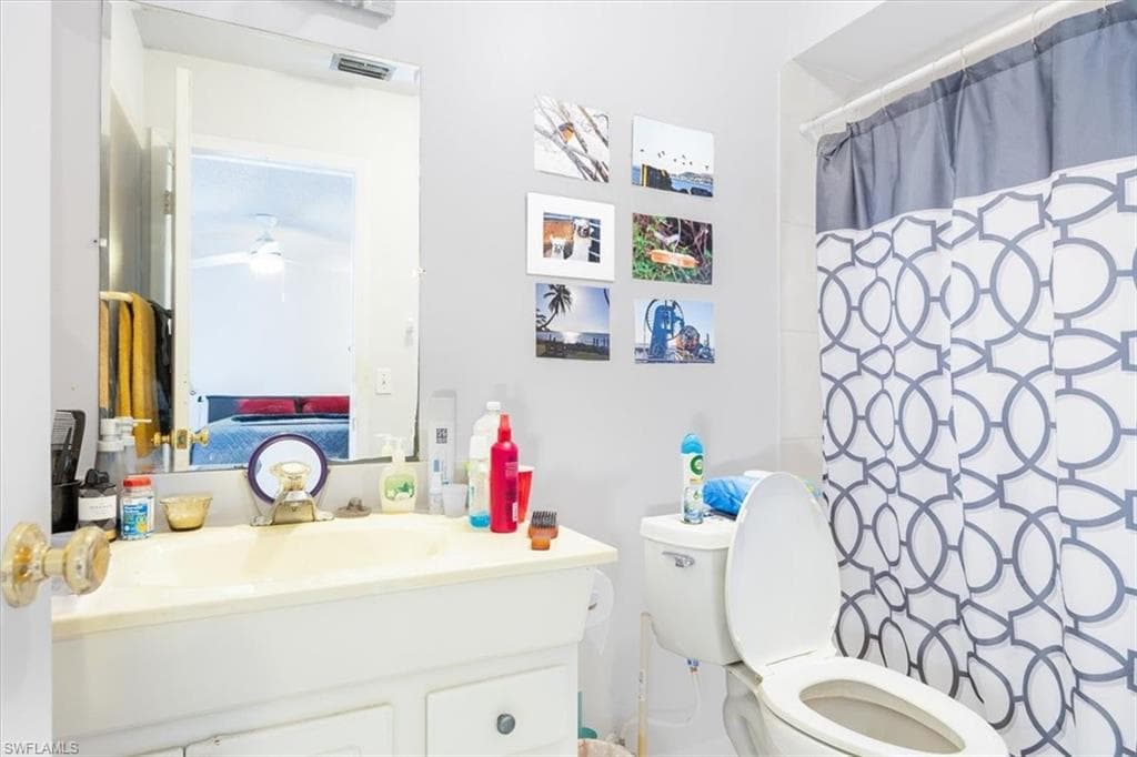 Bathroom featuring vanity and a shower with shower curtain