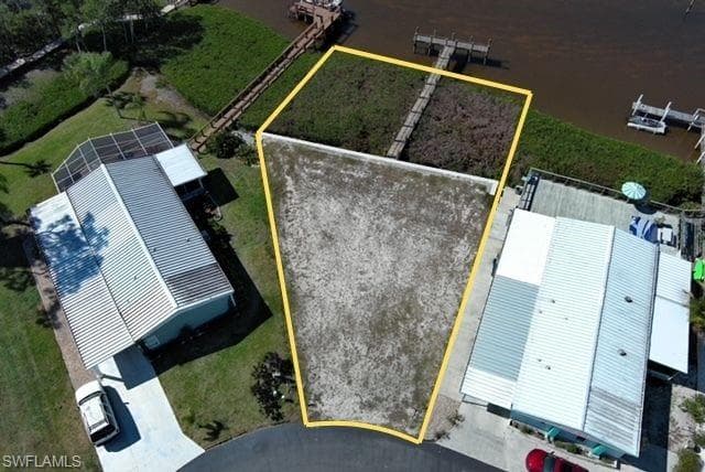 Aerial view of property and surrounding area featuring property parcel outlined