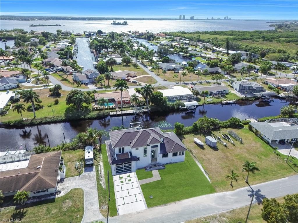 Aerial perspective of suburban area featuring a nearby body of water