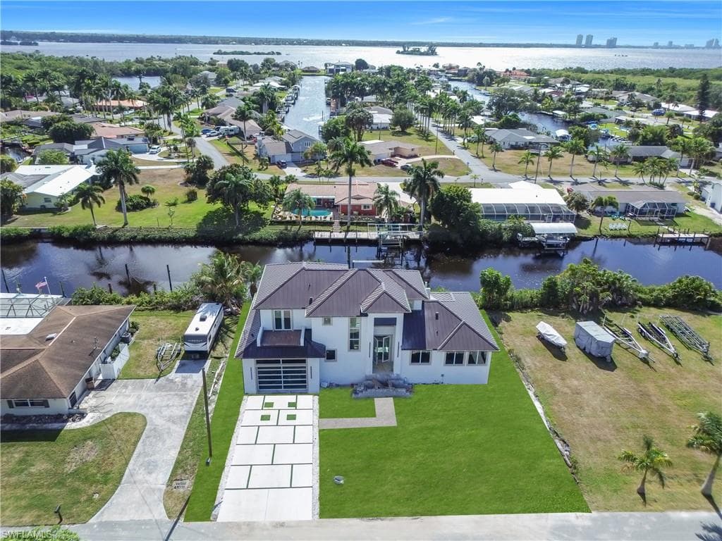 Aerial view of residential area featuring a nearby body of water