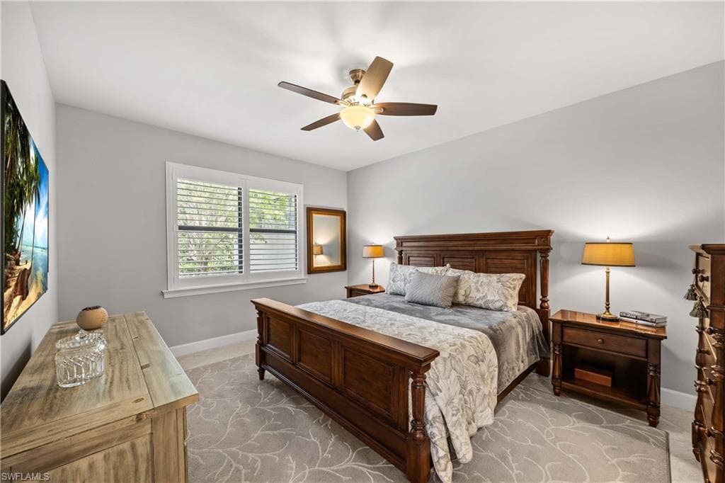 Primary bedroom with tile flooring and natural light throughout