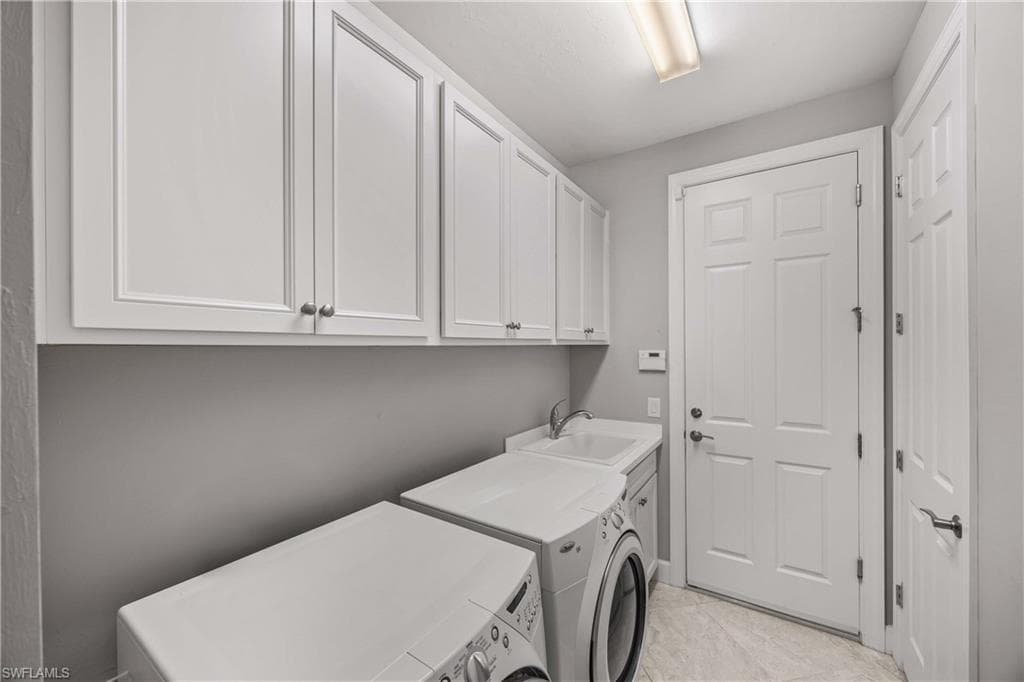 Laundry area featuring cabinet space and upgraded washer and dryer