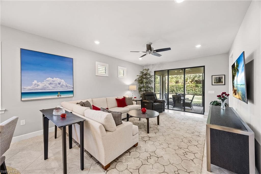 Living area featuring a ceiling fan and recessed lighting sliding doors lead to covered lanai