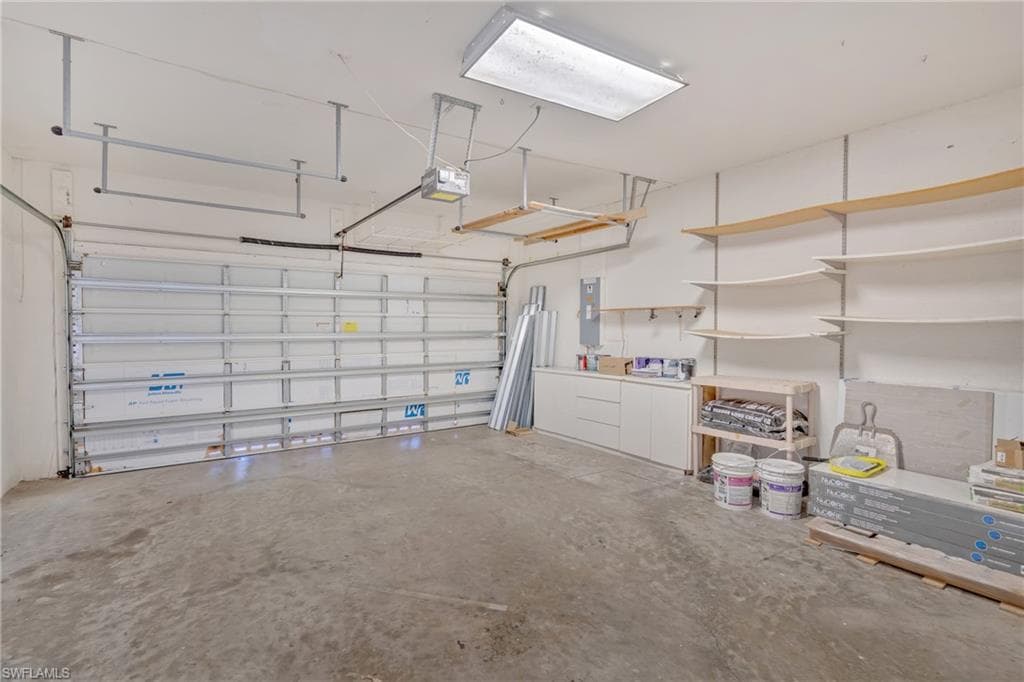 Garage with electric panel and a garage door opener