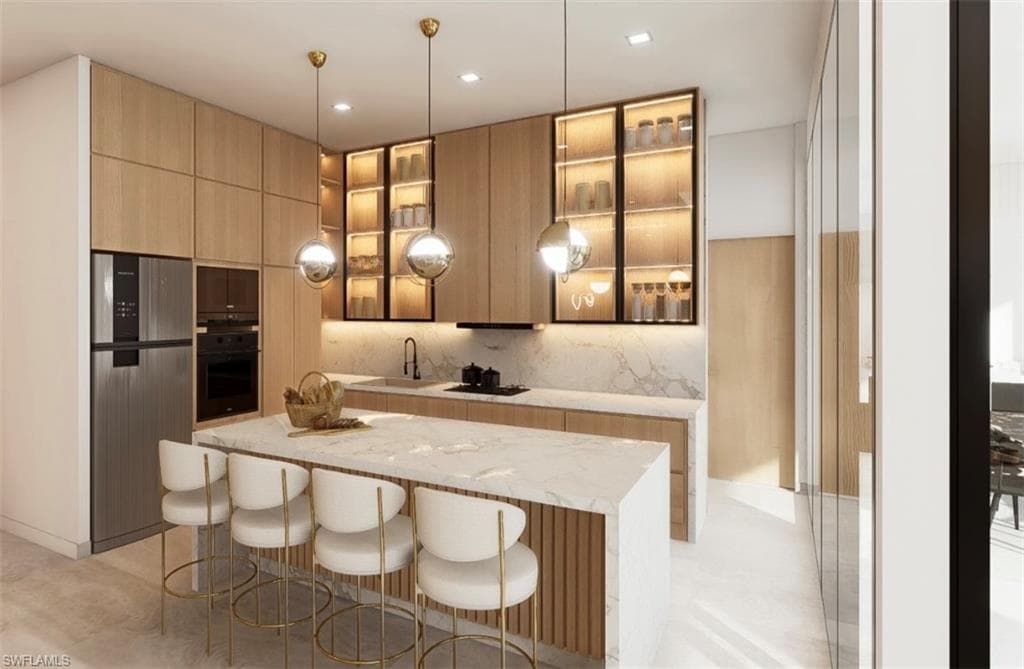 Kitchen featuring hanging light fixtures, light wood finish cabinetry, modern cabinets, and light stone countertops (Rendered photo)