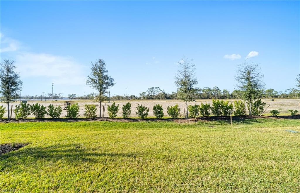 View of grassy yard with a rural view