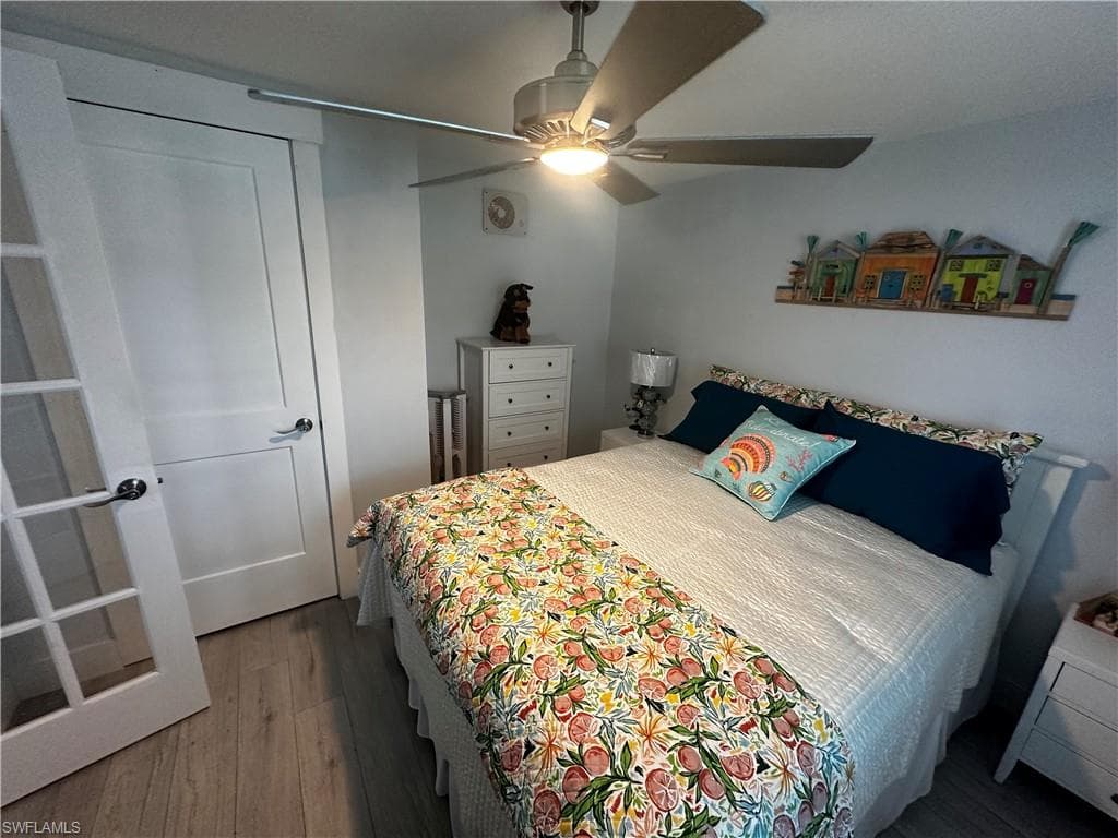 Bedroom featuring dark wood-type flooring and a ceiling fan