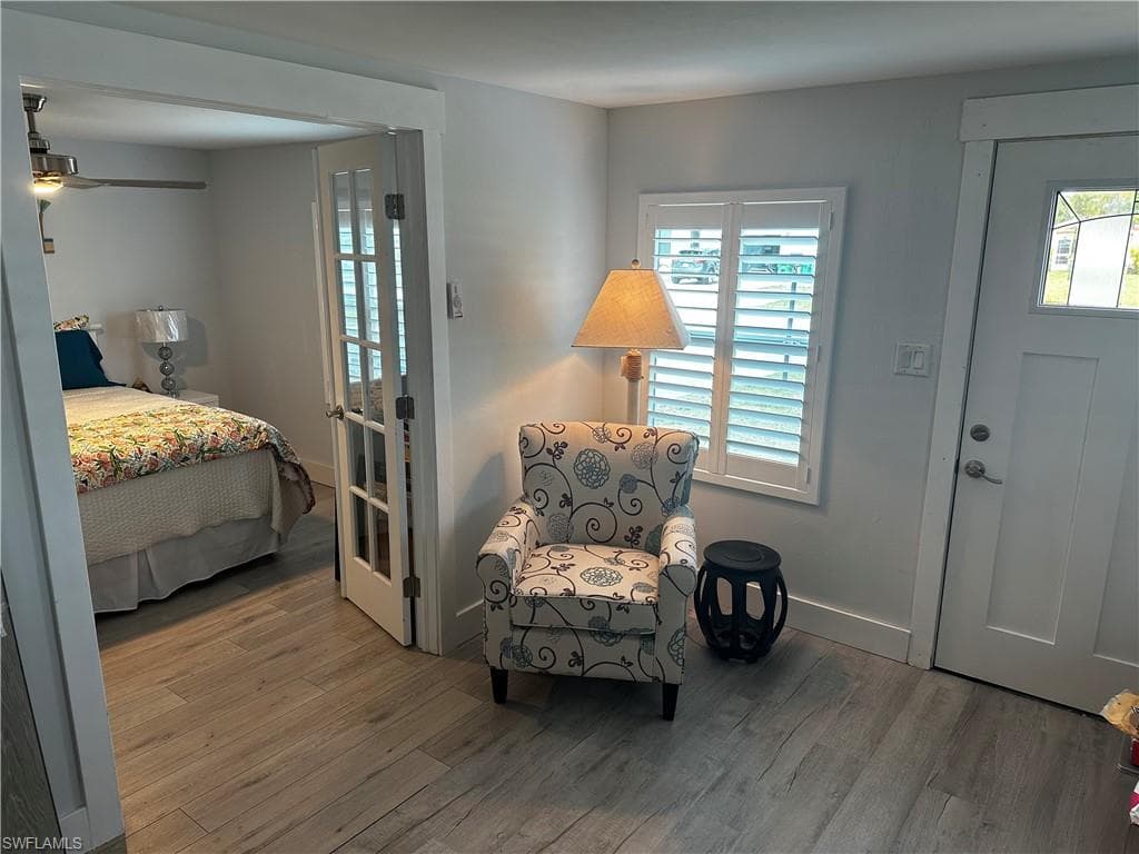Entryway with wood finished floors, ceiling fan, and healthy amount of natural light