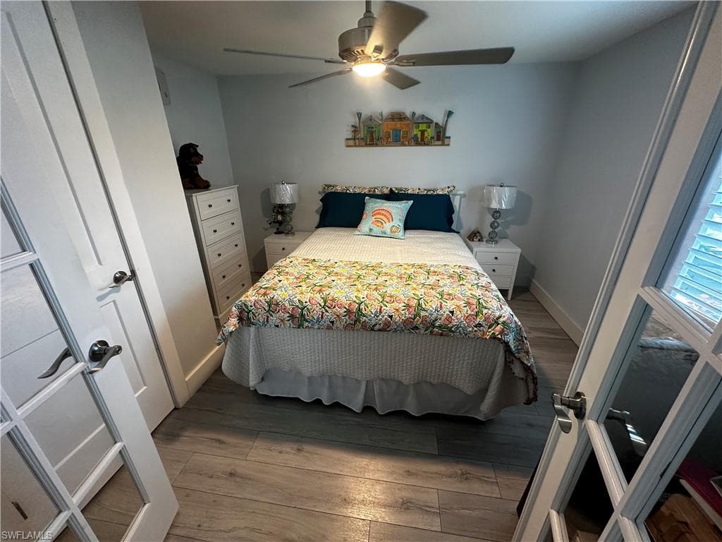 Bedroom with light wood-style floors and a ceiling fan