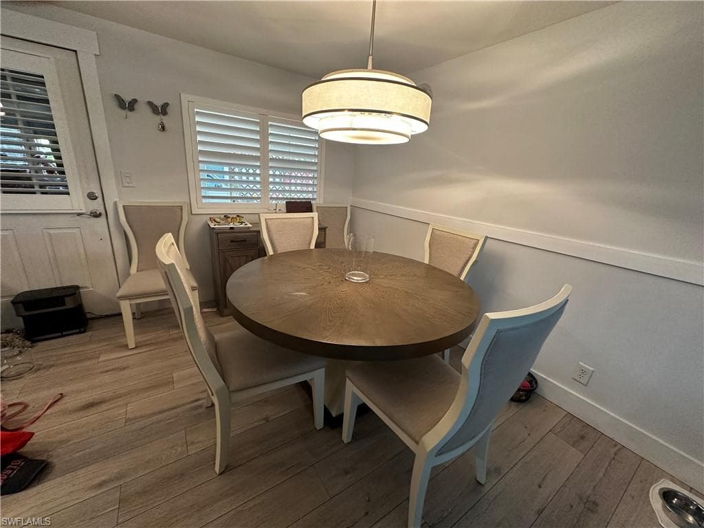 Dining area with wood-type flooring