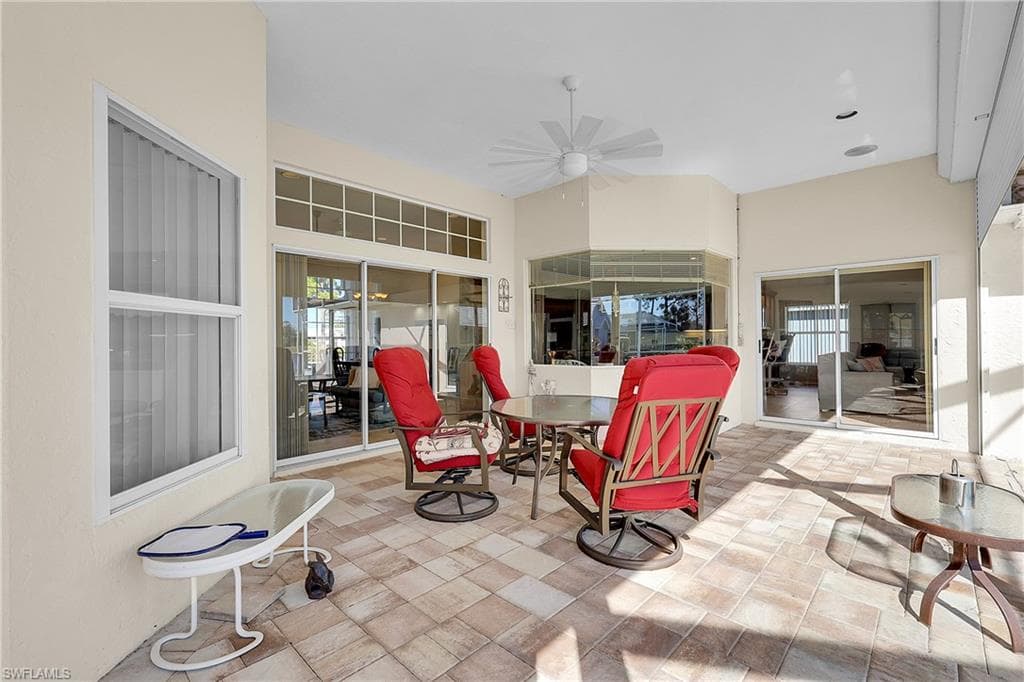 View of spacious covered patio featuring outdoor dining spaces, new ceiling fan and bay window to breakfast area. Patio has electric rolldown shutters, the rest of the home has accordian shutters and a few panel shutters for access.