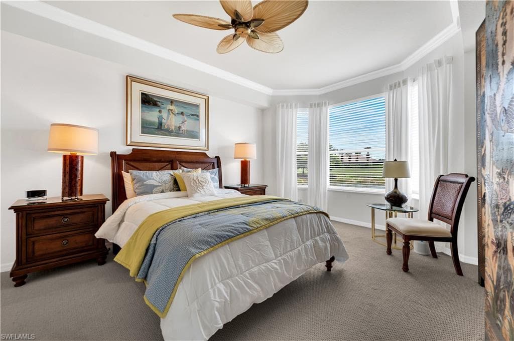 Primary bedroom with sitting area and views of the golf course and lake