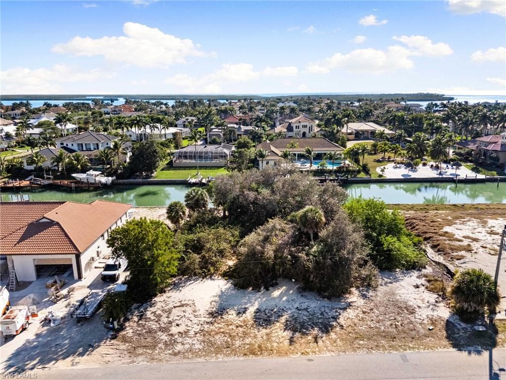 Aerial perspective of suburban area featuring a large body of water