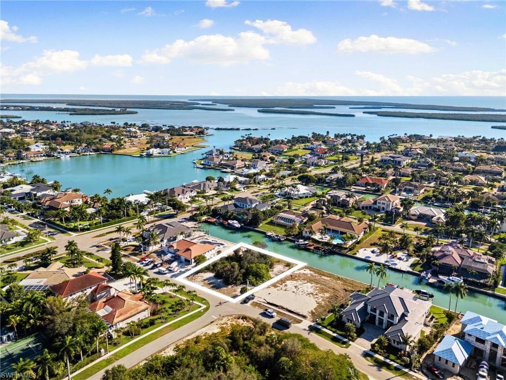 Aerial view of property's location with nearby suburban area and a nearby body of water
