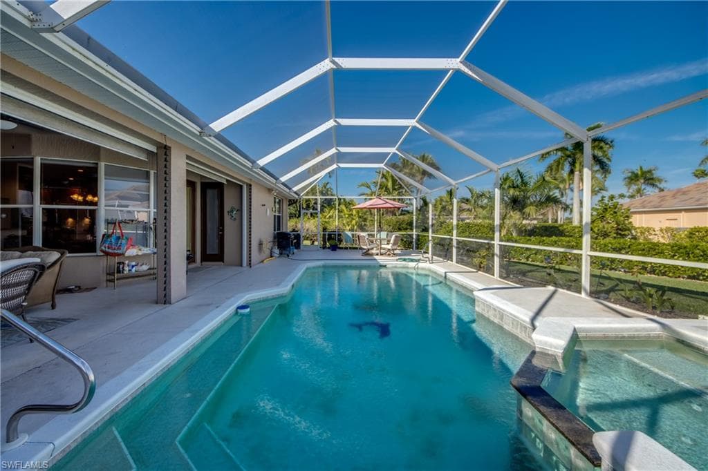 Integrated pool / spa featuring a lanai and a sunroom